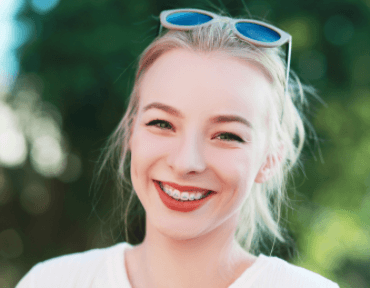 blonde girl with braces smiling